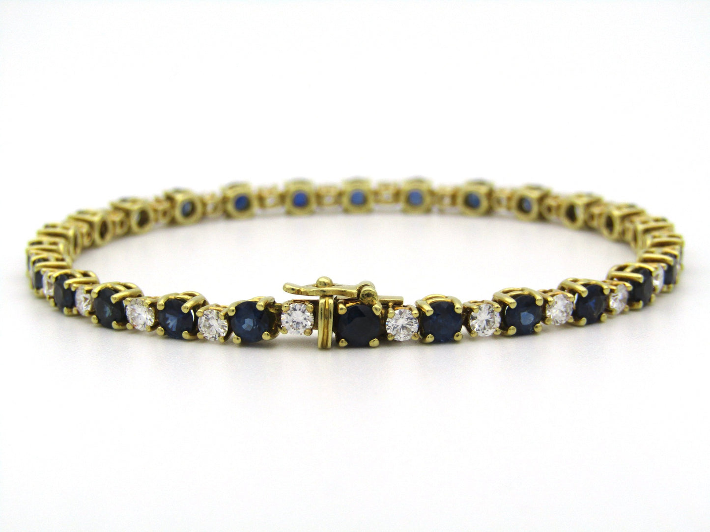 18K gold sapphire and diamond tennis bracelet.