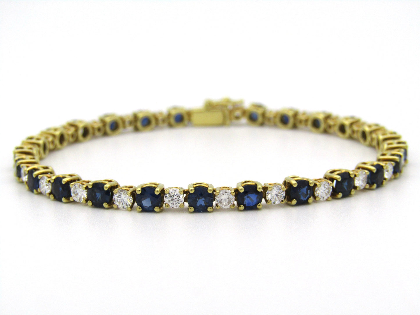 18K gold sapphire and diamond tennis bracelet.