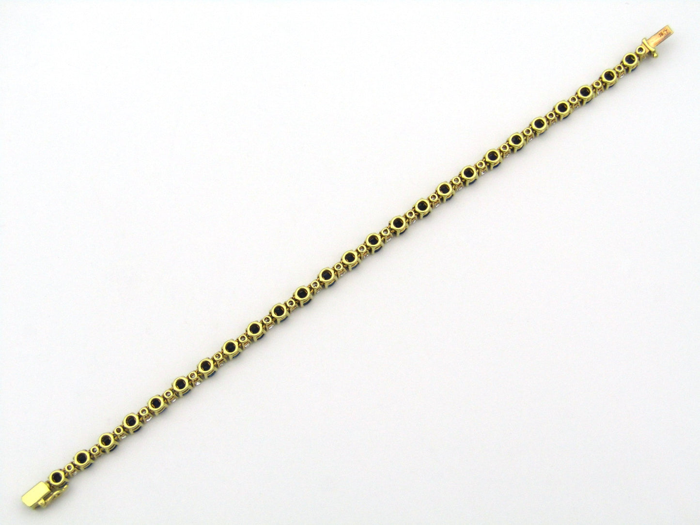 18K gold sapphire and diamond tennis bracelet.