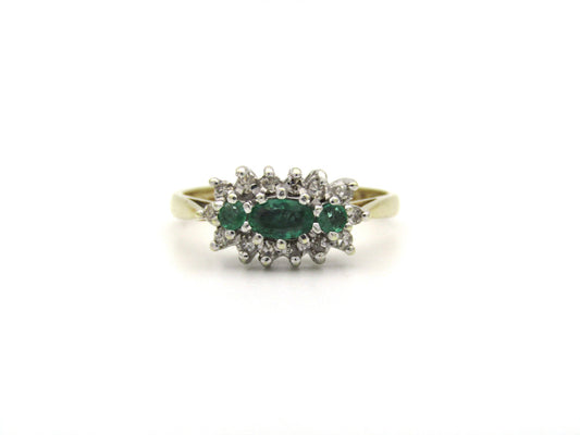 9K gold emerald and diamond ring.