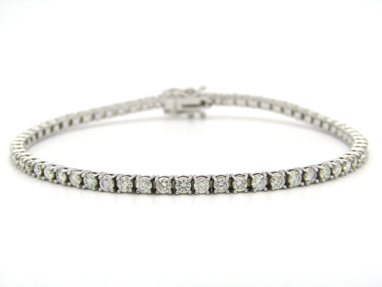 18K gold diamond tennis bracelet.